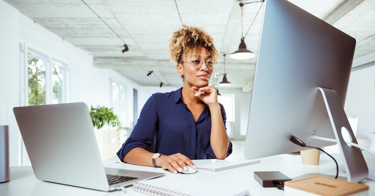 Photo of a woman looking at a computer screen, most likely using some sort of virtual agent software.