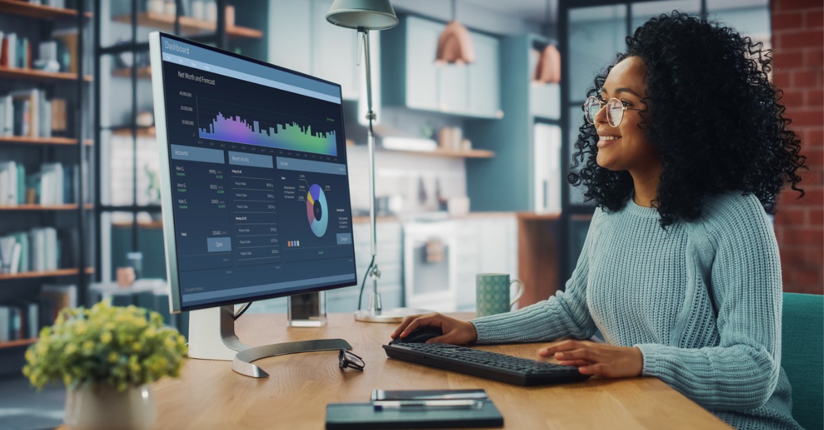 Photo of a business woman reviewing analytics and data related to customer experience management so she can determine the next best action for her customers