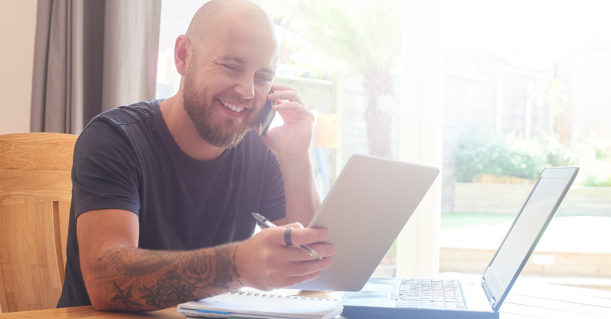 A man smiles while talking to a Dialogflow voicebot.