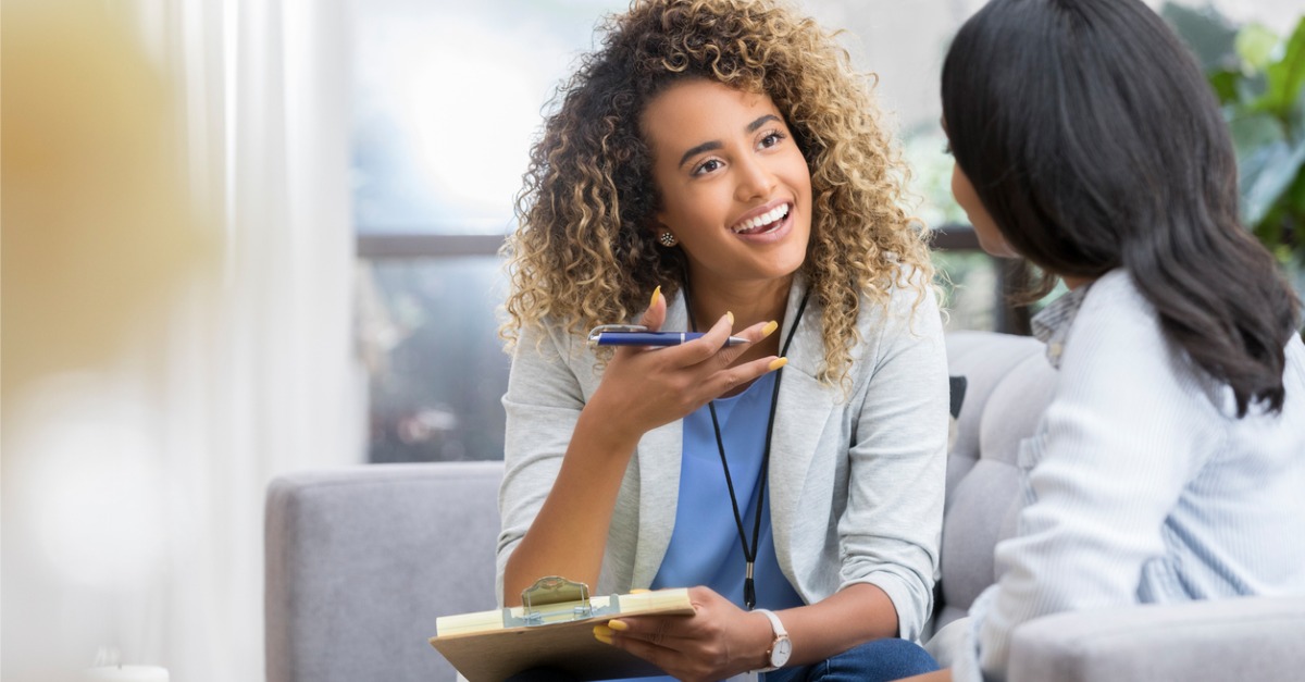 A doctor speaks to one of her patients, creating a positive patient experience.