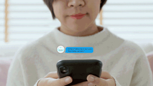 Gif: A person sends text messages to a bot, and the bot responds. Messages pop up above a smartphone to show what is said between the customer and intelligent virtual assistant.