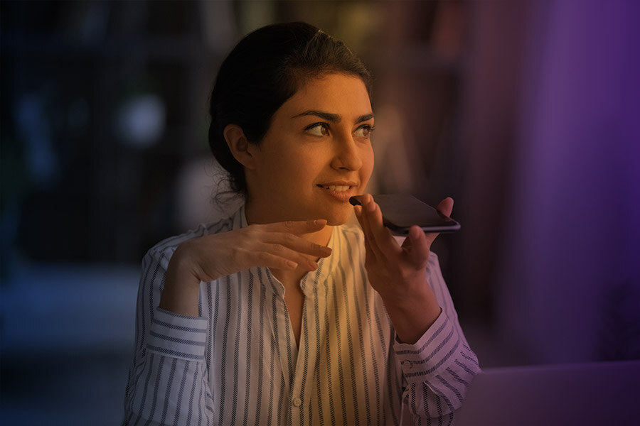 Woman using speaker phone.